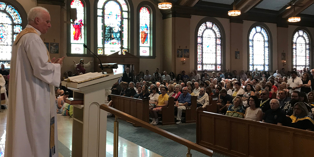 Faithful jam Holy Rosary Church for Mass as the feast of the Assumption celebration begins
