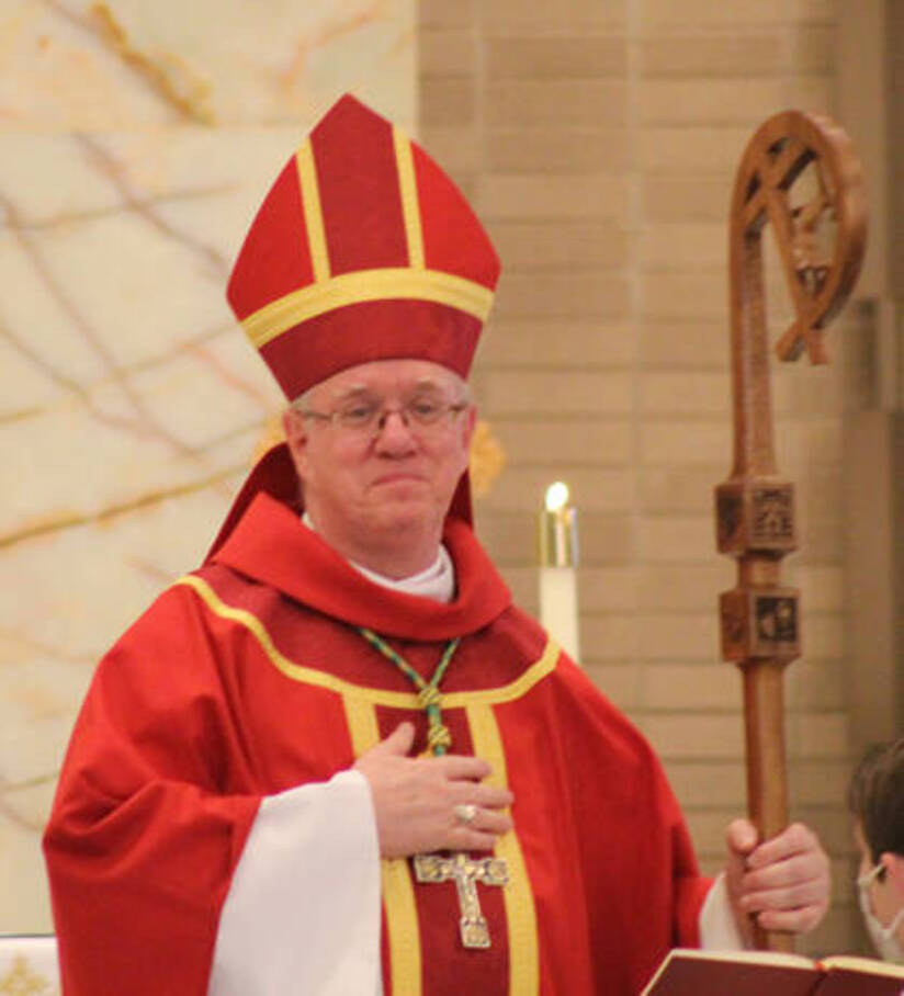 Bishop woost in red vestments